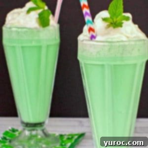 Emerald Grasshopper Mocktail 13 Two non-alcoholic Grasshopper drinks on a white surface with a black background, garnished and ready to serve.