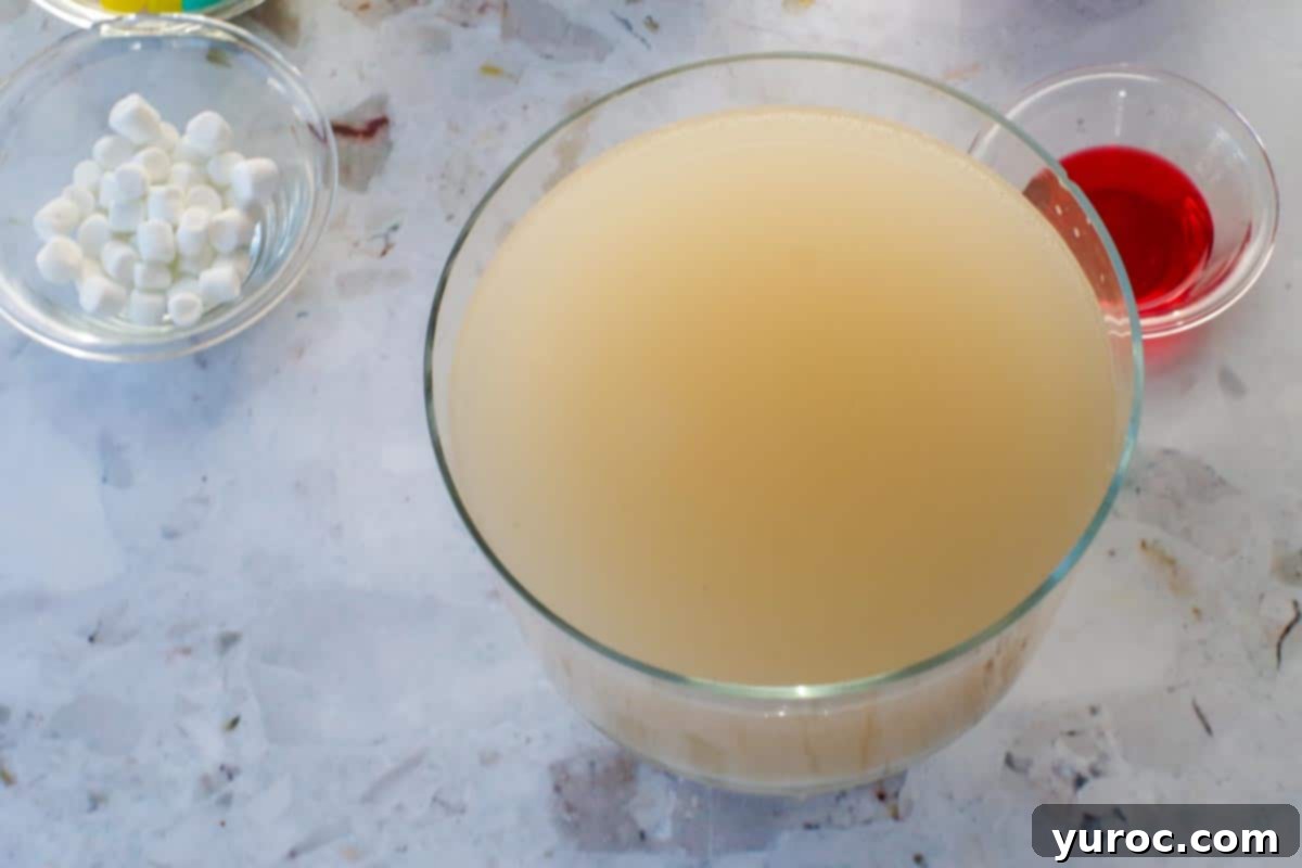 Pina Colada mix mixed with ginger ale and sparkling water in a glass trifle bowl
