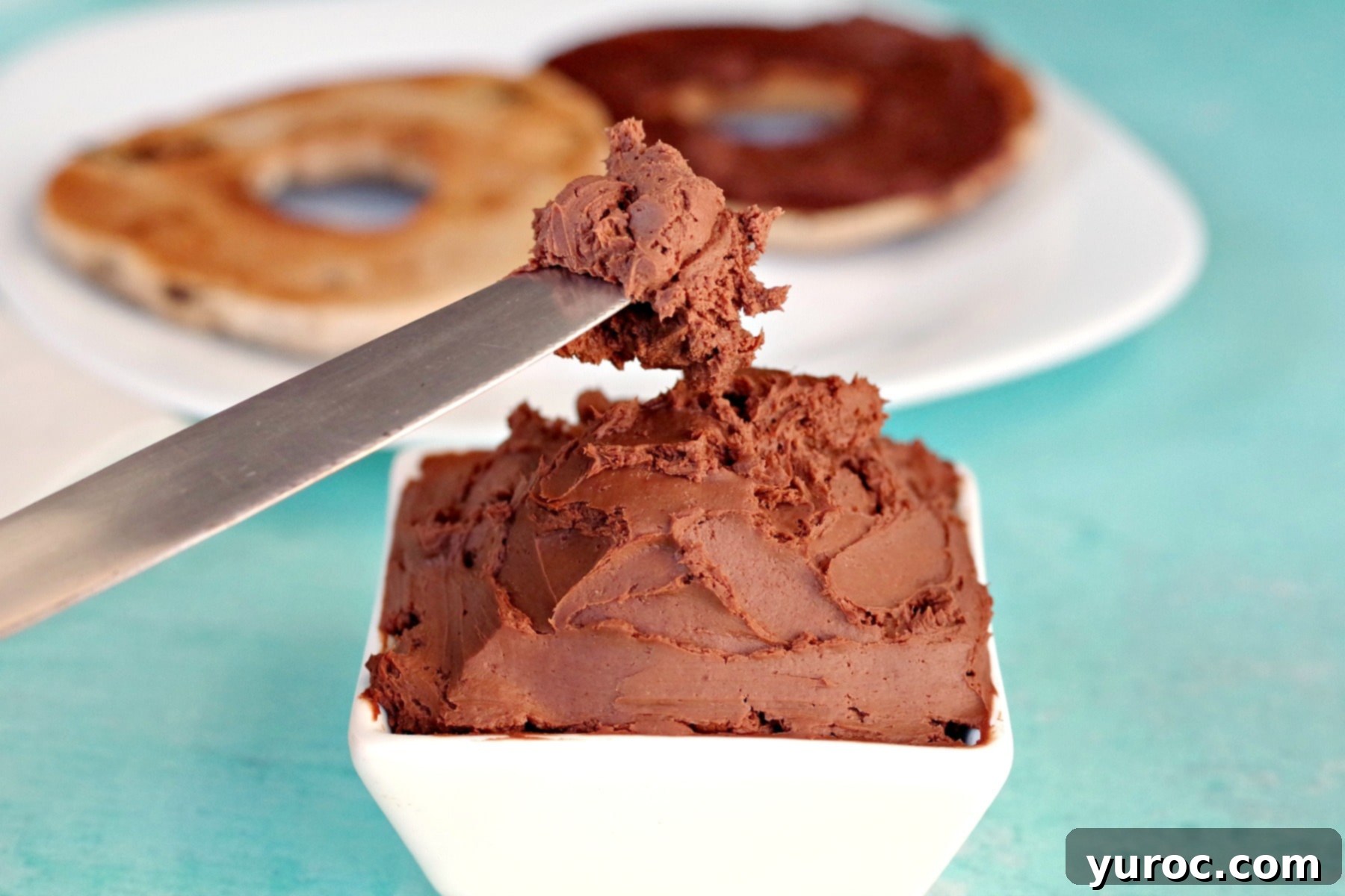 Decadent 3-Ingredient Chocolate Cream Cheese Spread 1 Knife with rich, homemade chocolate cream cheese spread on it, ready for tasting.