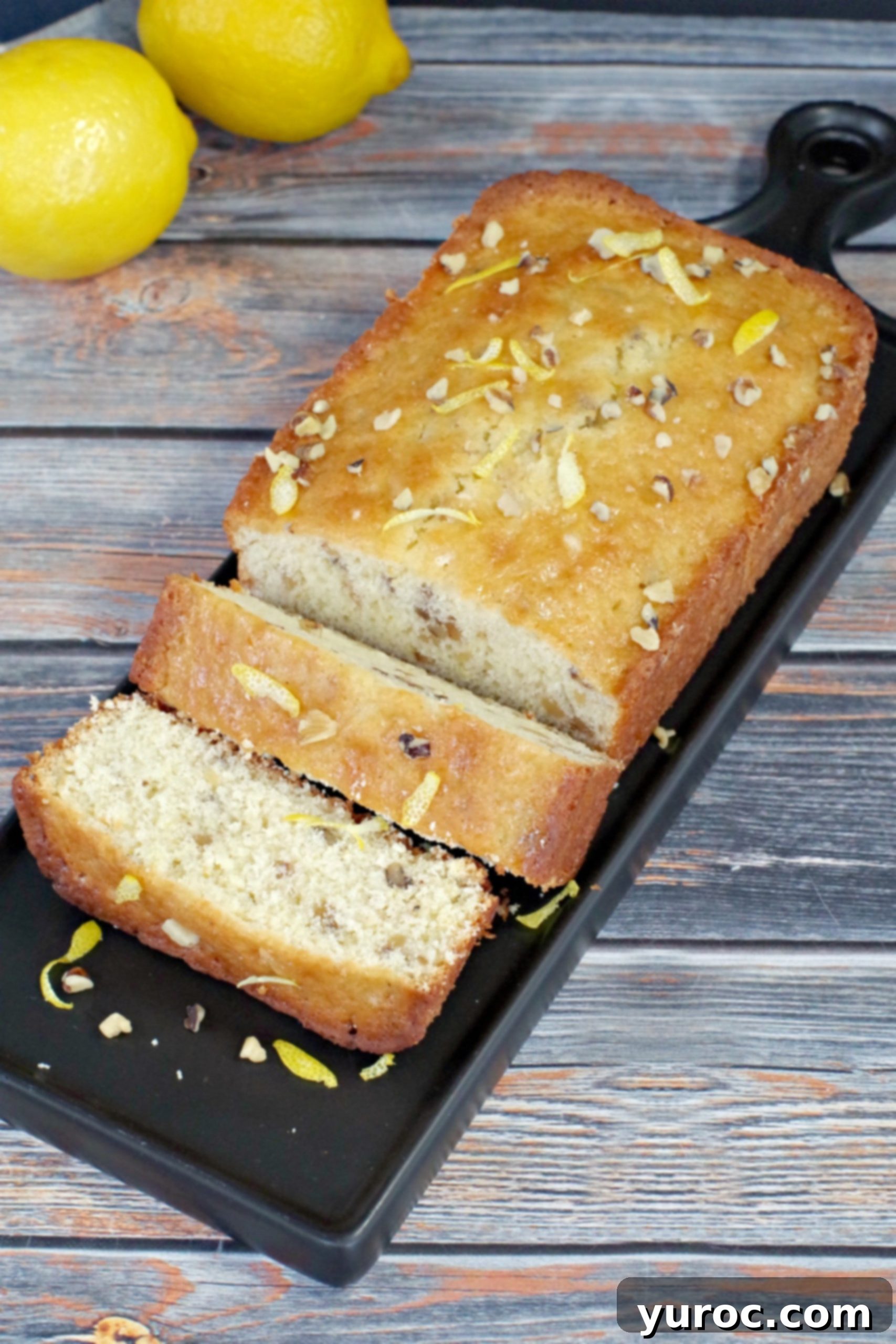 Several slices of lemon loaf artfully arranged on a black tray, ready to be served