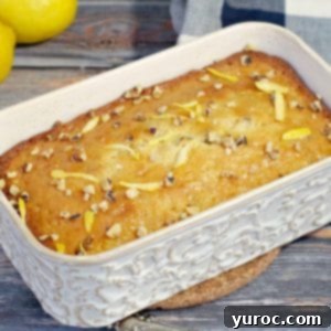 Classic lemon loaf baked in an off-white ceramic loaf pan