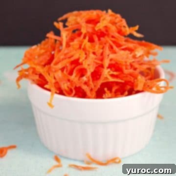 Candied carrots in a small white dish, a close-up for the recipe card