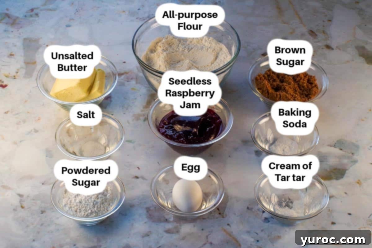 Key ingredients for raspberry jam cookies displayed in clear glass bowls, neatly labelled for easy identification.