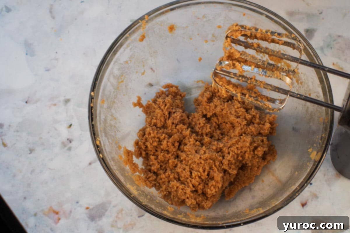 Egg beaten into brown sugar and butter mixture in large glass bowl.