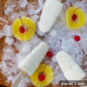 Cool & Creamy Virgin Pina Colada Pops 12 Creamy Piña Colada popsicles garnished with pineapple and cherries, ready to enjoy.