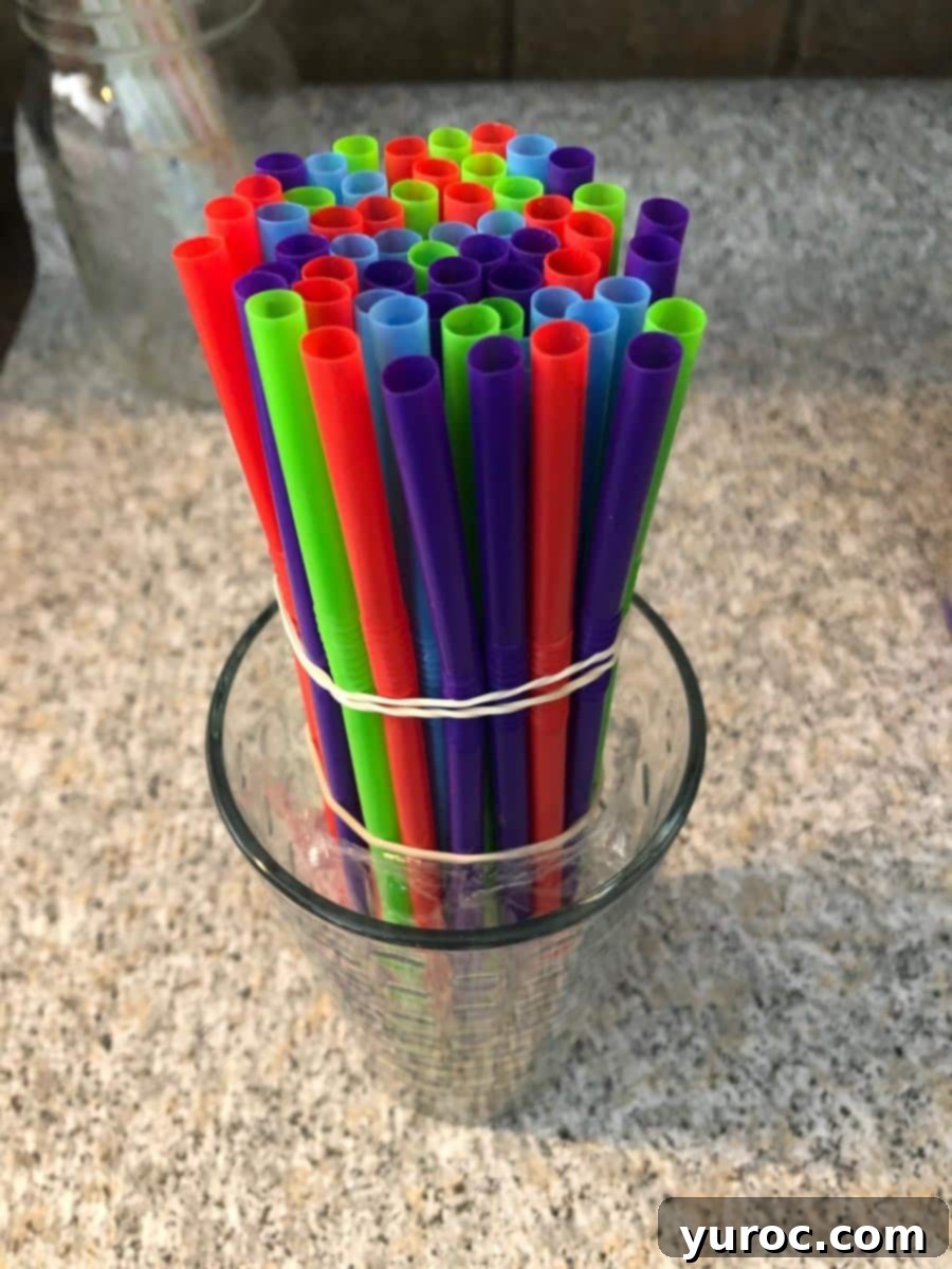straws held together with elastic and placed in a cup