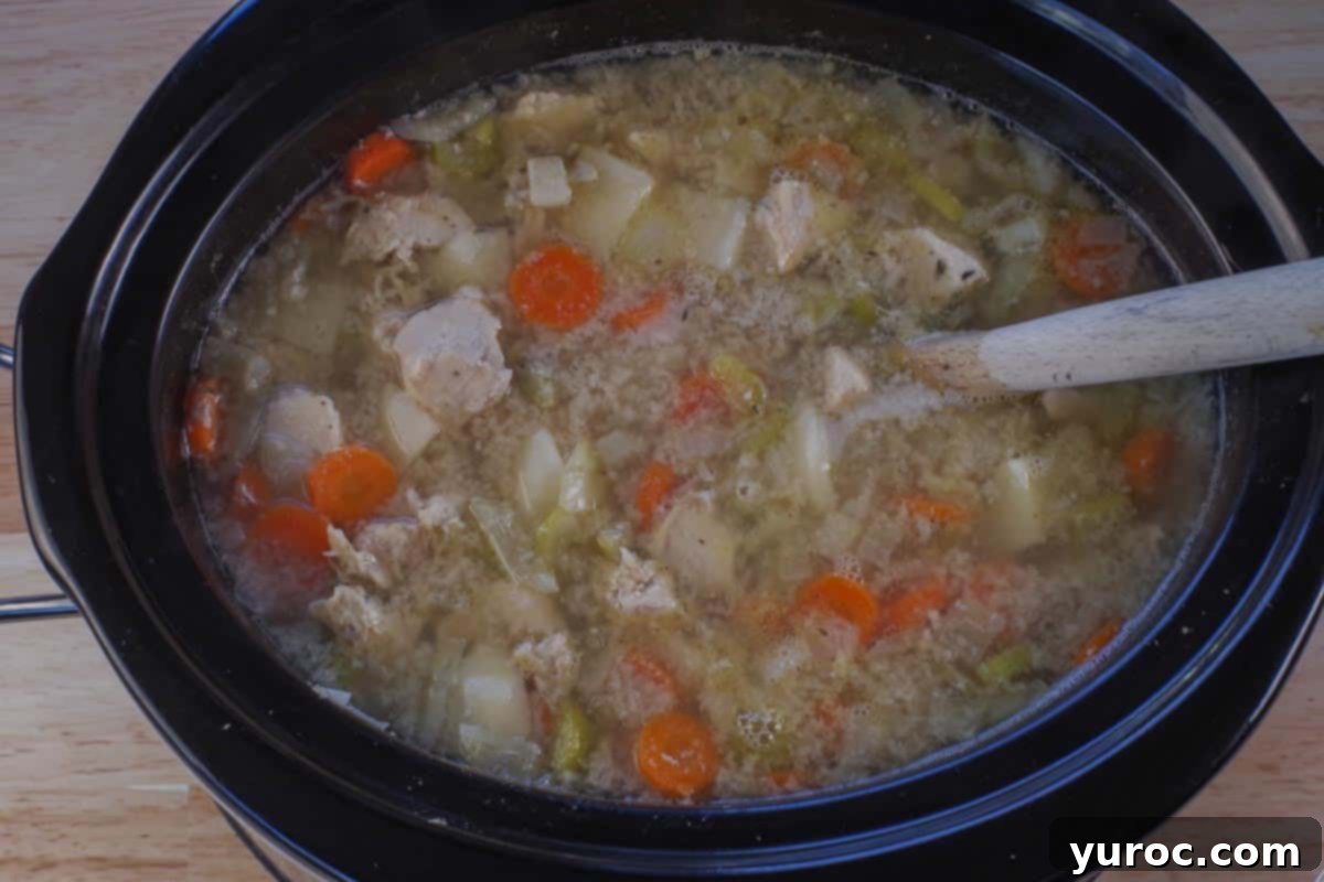 Nourishing Slow Cooker Chicken Stew 9 roux being stirred into slow cooker chicken stew