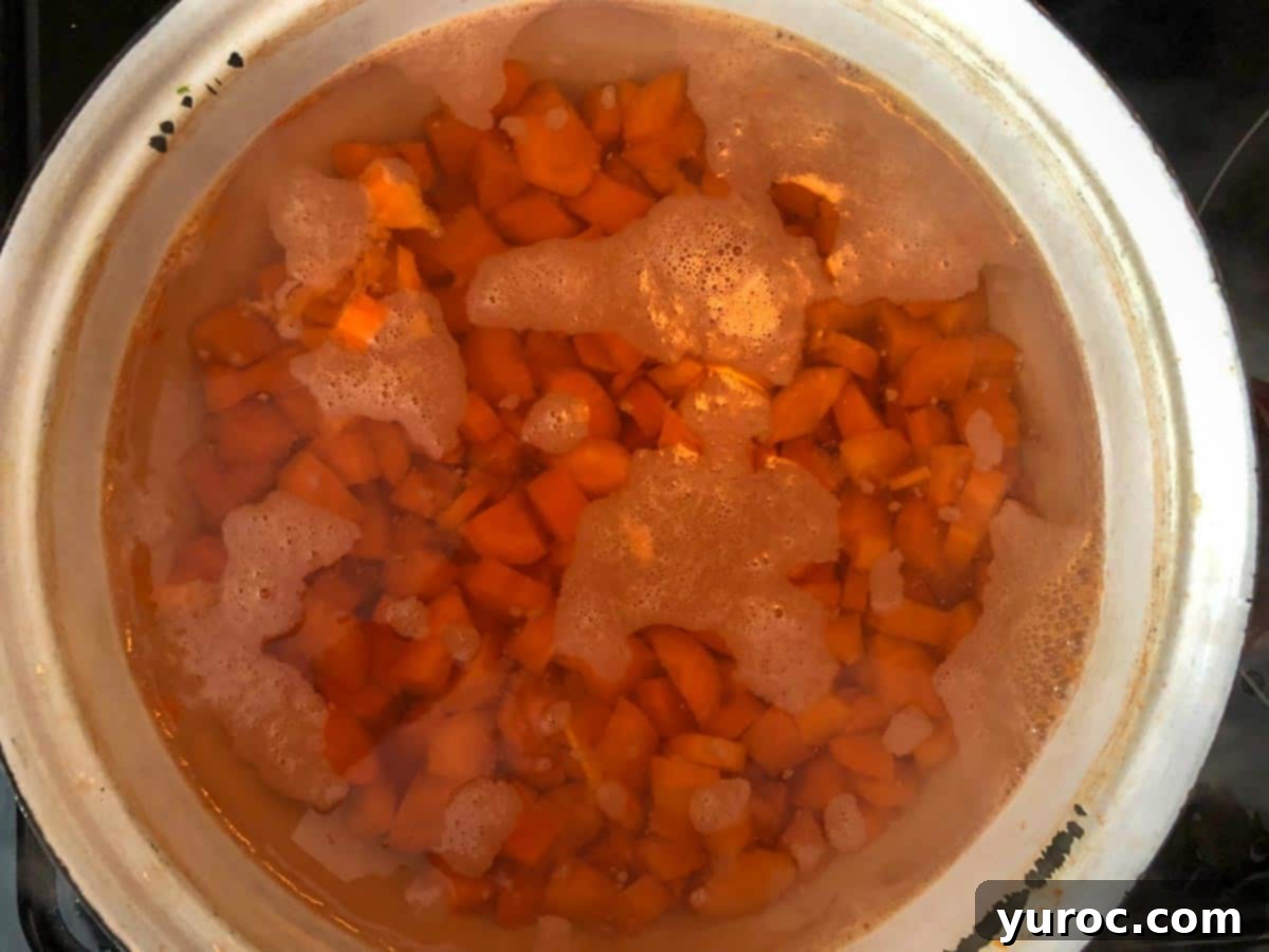 carrots cooking in pot in boiling water