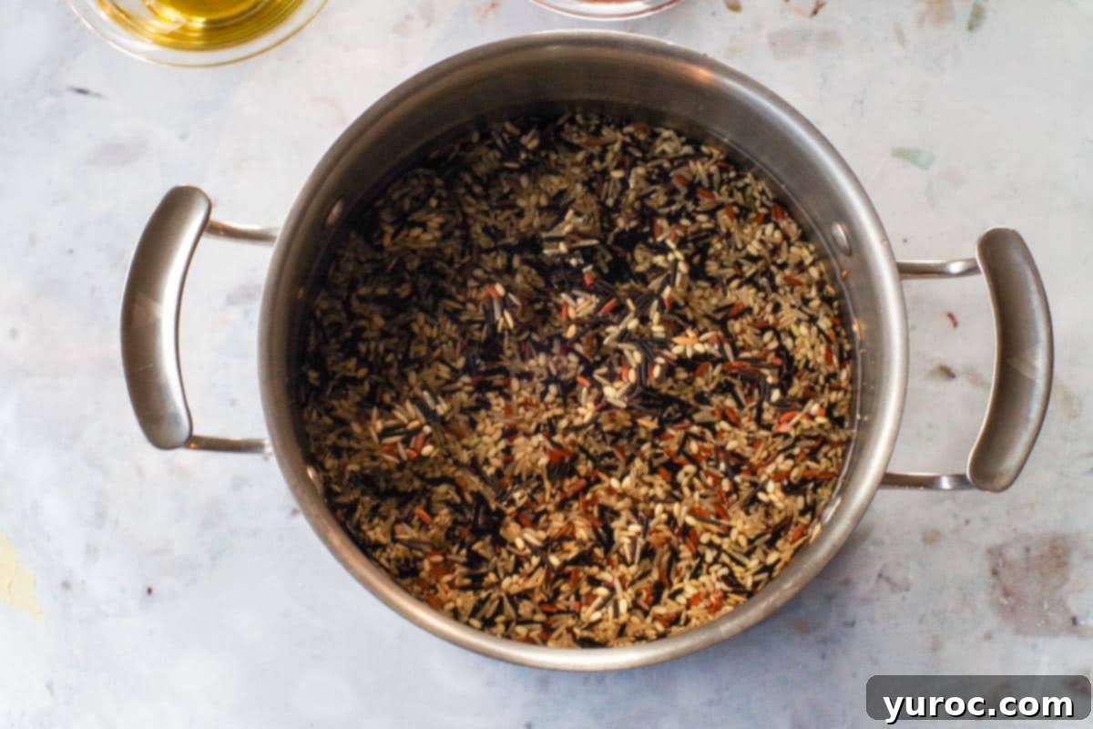 Zesty Mediterranean Chicken Rice Cups 5 Wild and Brown Rice Medley being cooked in a medium pot, releasing steam