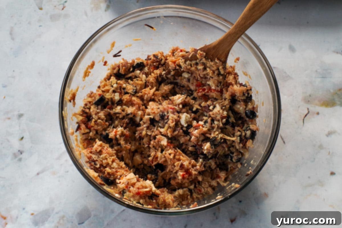 Zesty Mediterranean Chicken Rice Cups 7 All ingredients for the rice cups, including rice, chicken mixture, eggs, olives, and feta, mixed together in a large bowl