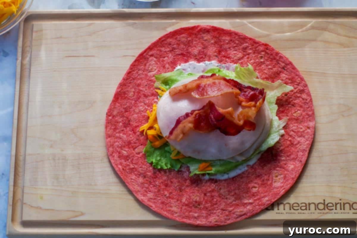 Ultimate Turkey Bacon Ranch Wrap 6 A tortilla wrap with all the fillings: ranch, lettuce, carrots, cheese, turkey slices, and crispy bacon.