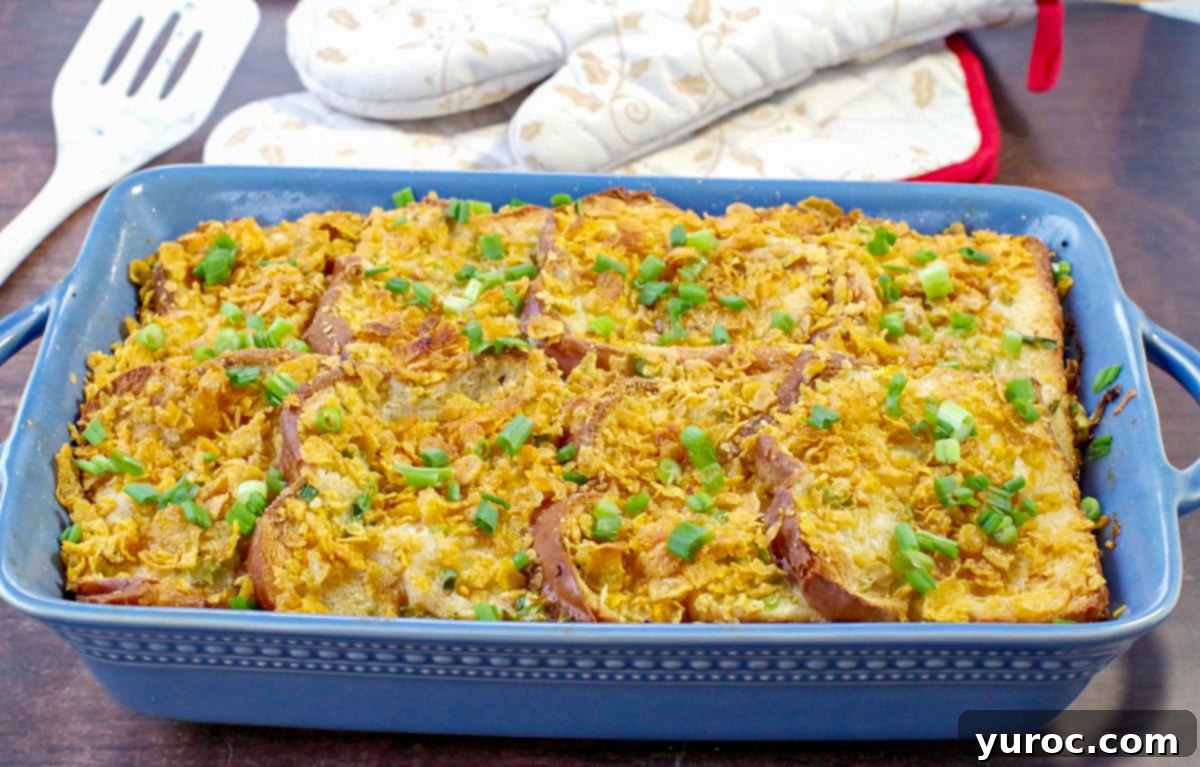 Stress-Free Christmas Breakfast Bake 3 Christmas breakfast casserole in blue casserole dish with white and gold Christmas oven mitts in the background