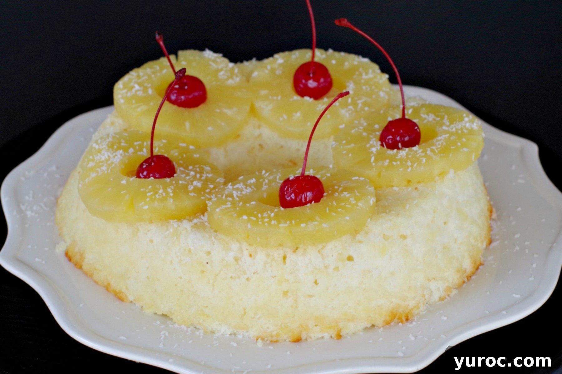 Weight Watchers Pina Colada Angel Food Cake, garnished with pineapple and cherries