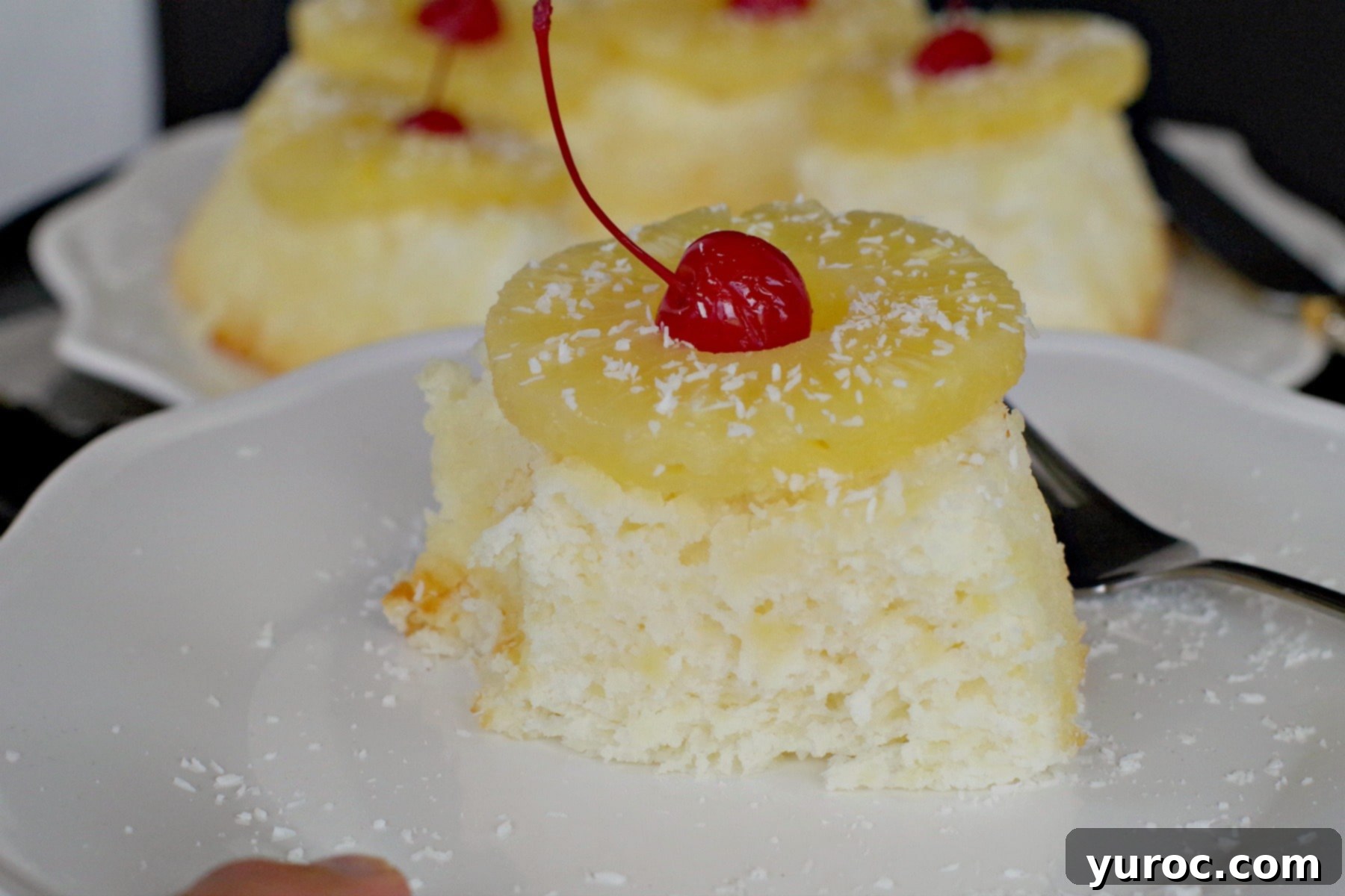 A slice of Weight Watchers Pina Colada Angel Food Cake on a white plate