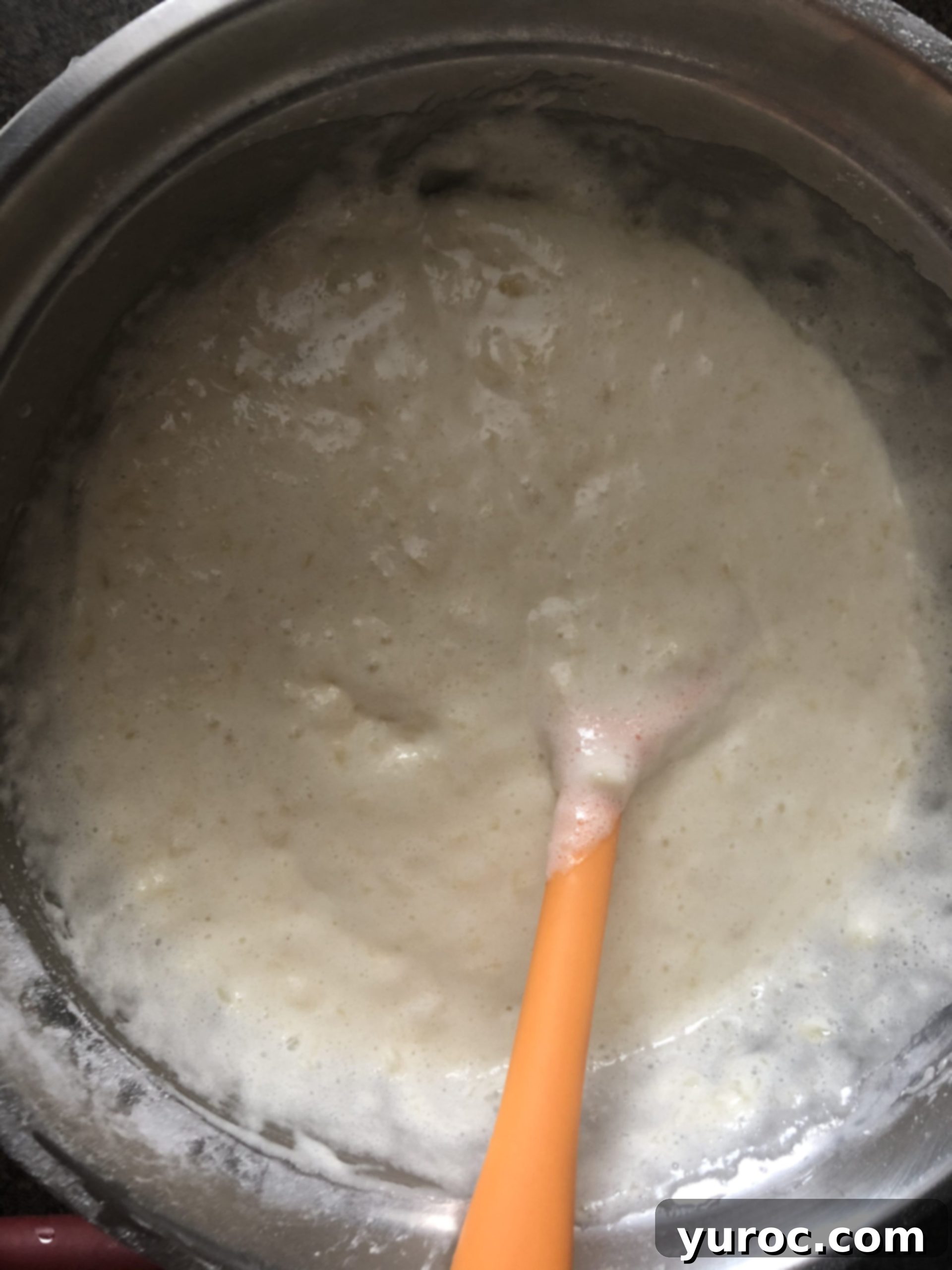 Mixed ingredients becoming frothy, showing the reaction between cake mix and pineapple