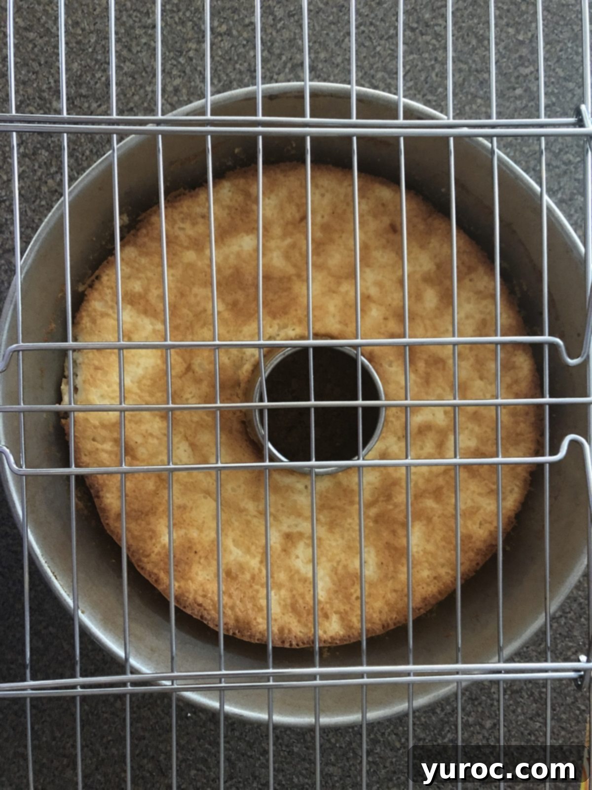 Cooling rack placed on top of the angel food cake pan, ready for flipping, showing the optimal method