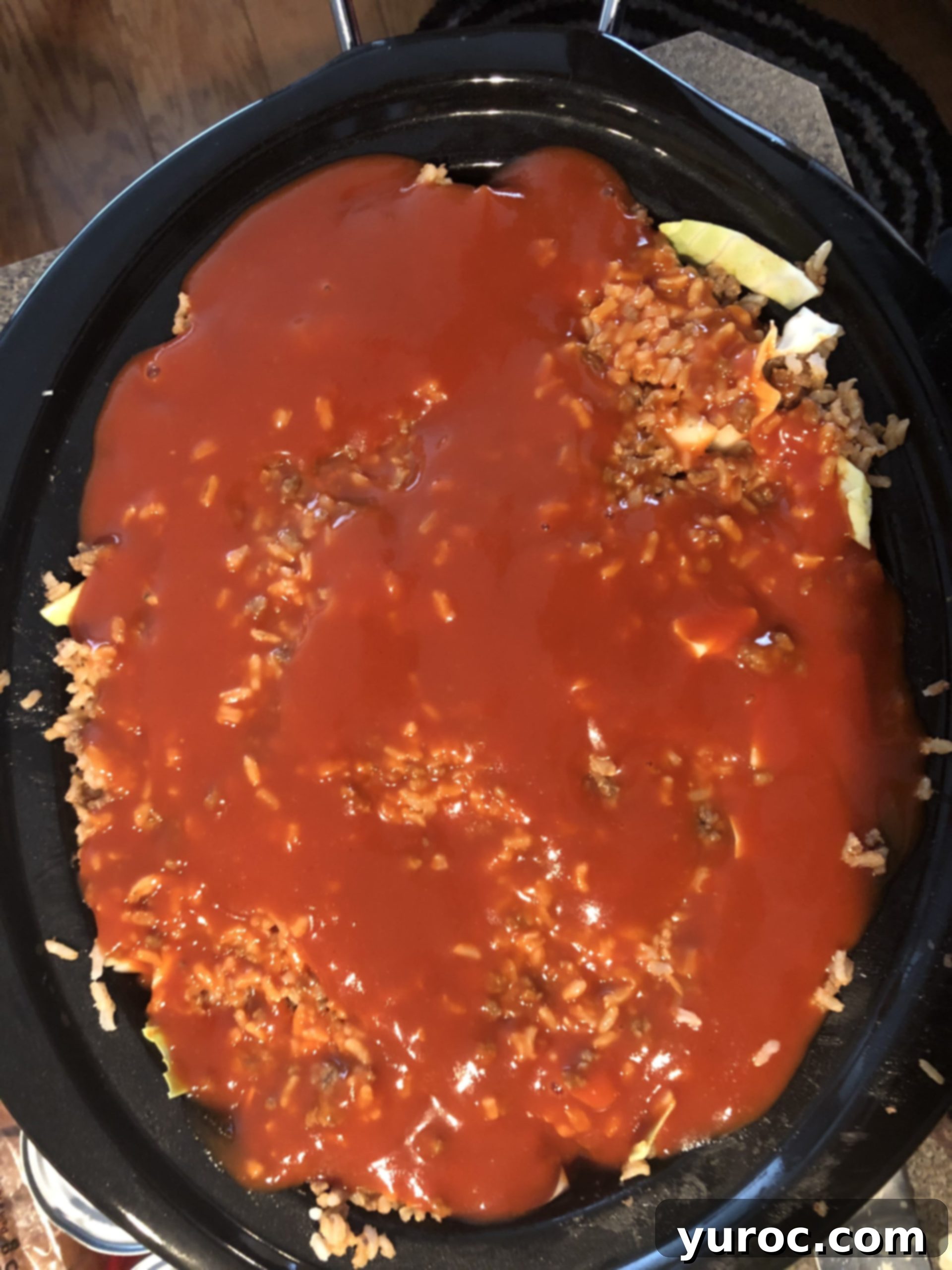 2nd layer of meat and rice mixture on cabbage , with 2 cans of tomato soup on top