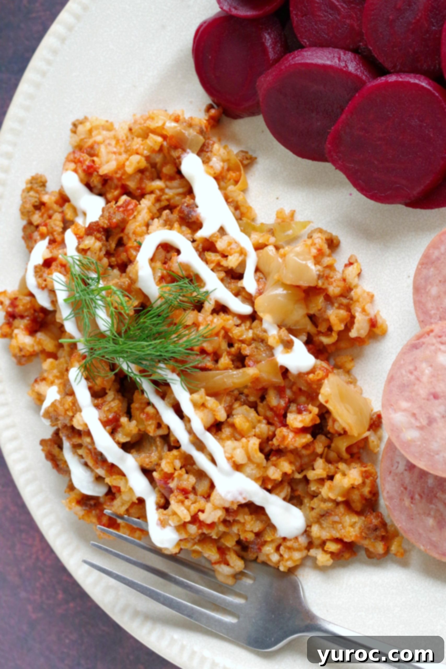 pin with text and photo of plate of lazy cabbage rolls with beets and kielbasa