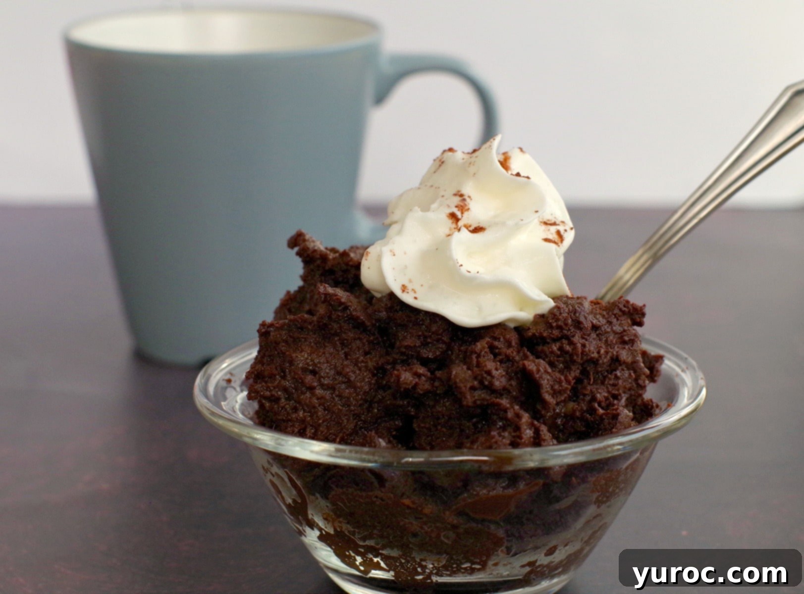 Instant Guilt-Free Chocolate Banana Mug Cake 5 A healthy microwave chocolate banana mug cake served in a clear glass bowl, showcasing its moist texture.