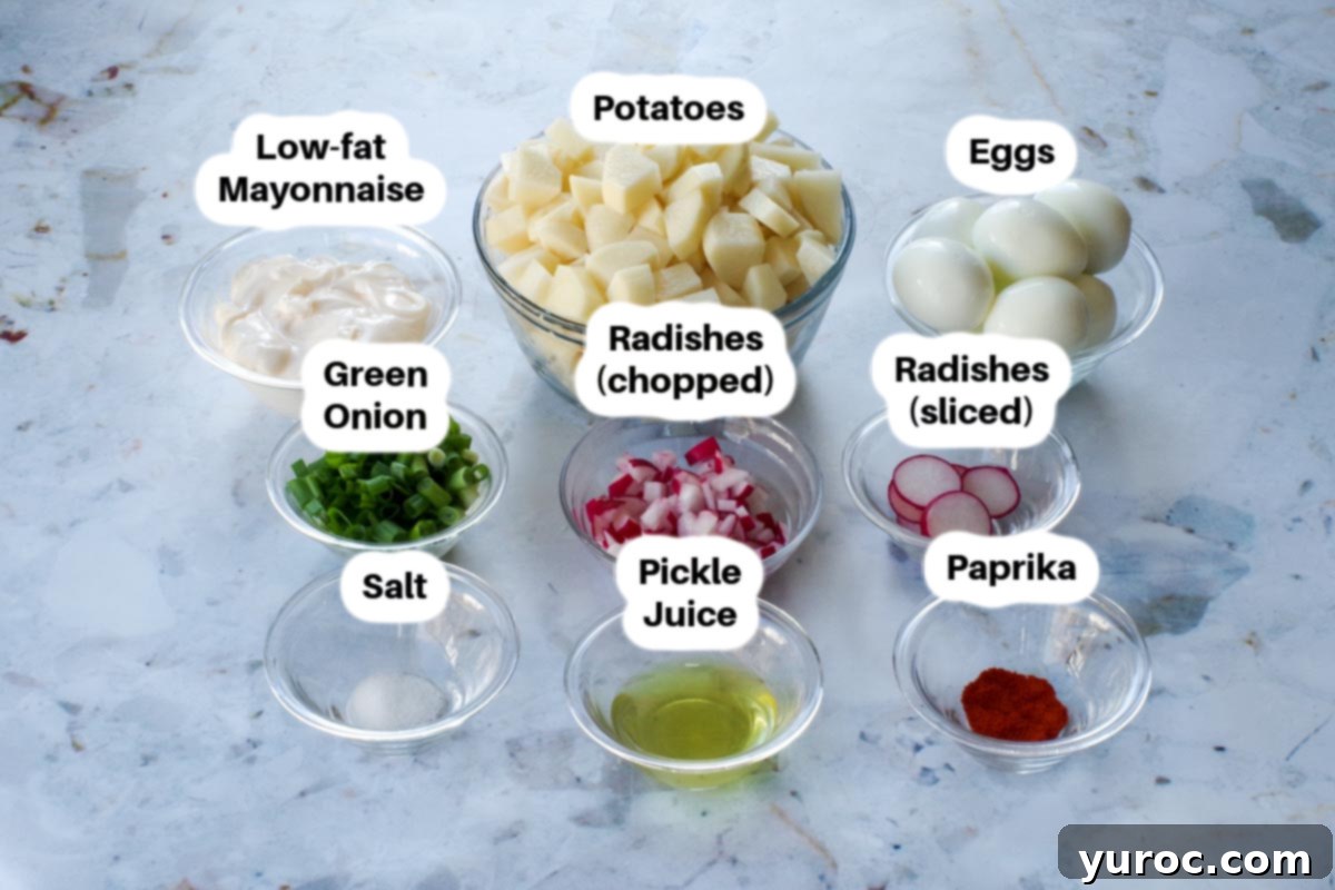 Healthy potato salad ingredient in glass bowls, labelled.