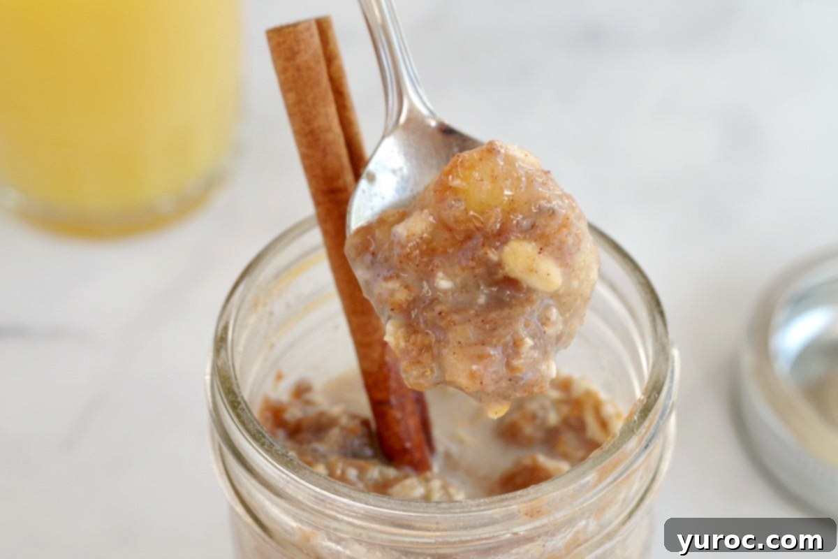 Wholesome Bananas Foster Overnight Oats 3 overnight oats being held up with a spoon