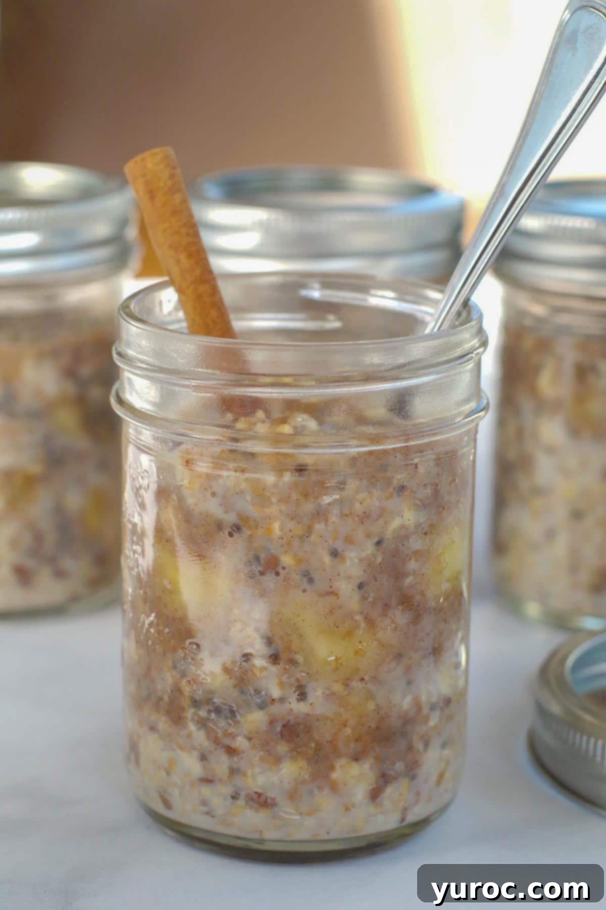 Bananas Foster Overnight Oats in a jar with jars in overnight oats behind