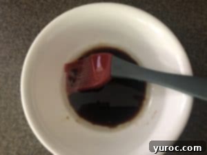 oil and balsamic vinegar mixed together in white bowl
