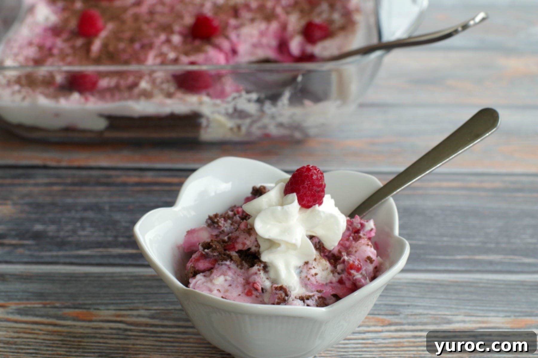 weight watchers white chocolate raspberry cheesecake dessert in white dish with glass dish in background