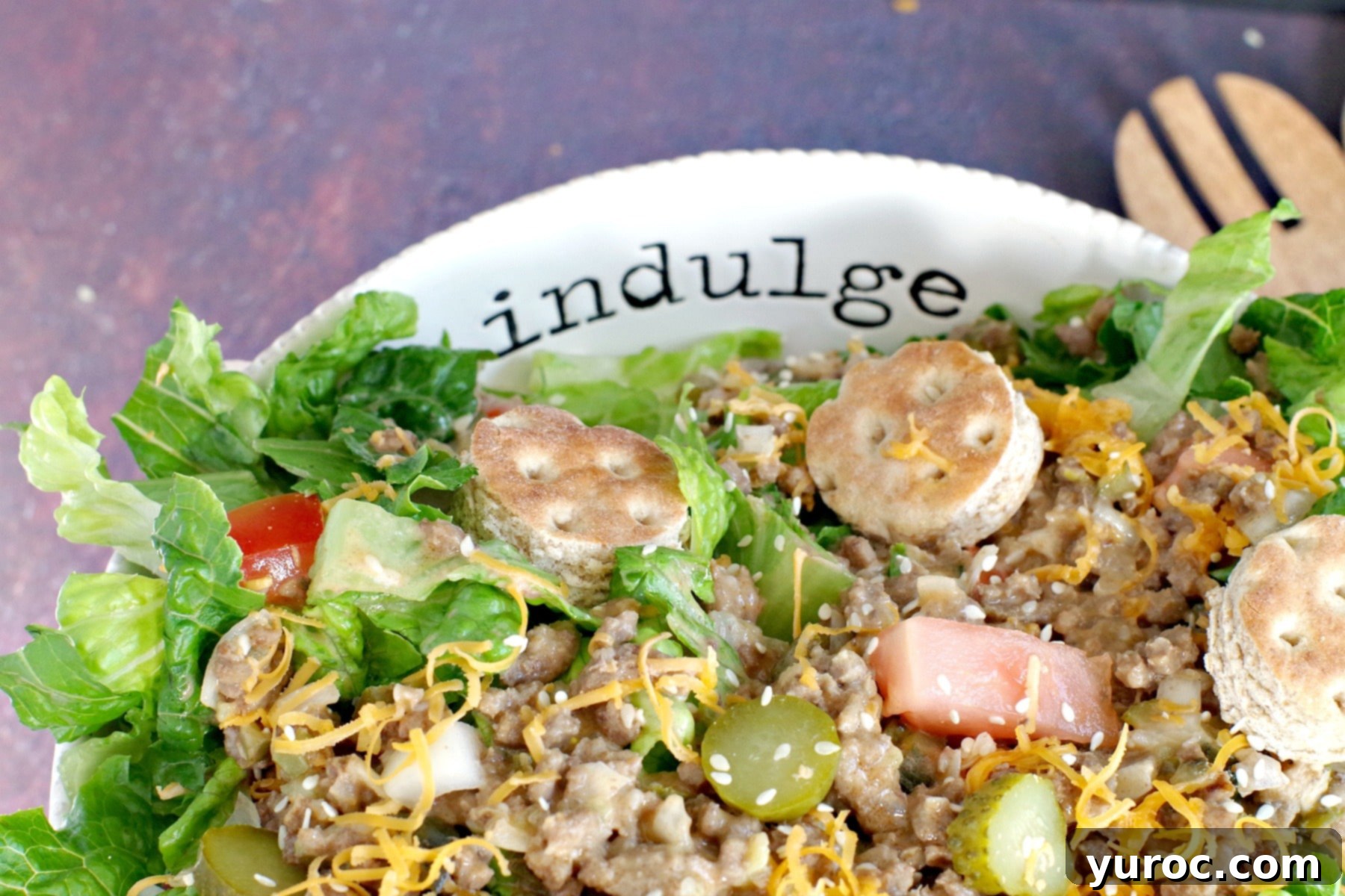 Big Mac salad (from top) in white bowl) with word "indulge" written on bowl