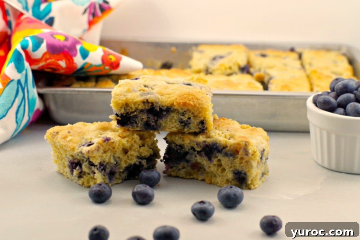 Healthy and light blueberry cornbread slices on a cooling rack.