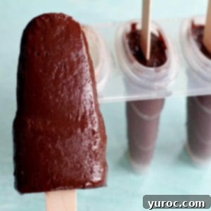 Decadent Yet Light Chocolate Banana Pops 7 banana fudge popsicle with popsicle mold in the background