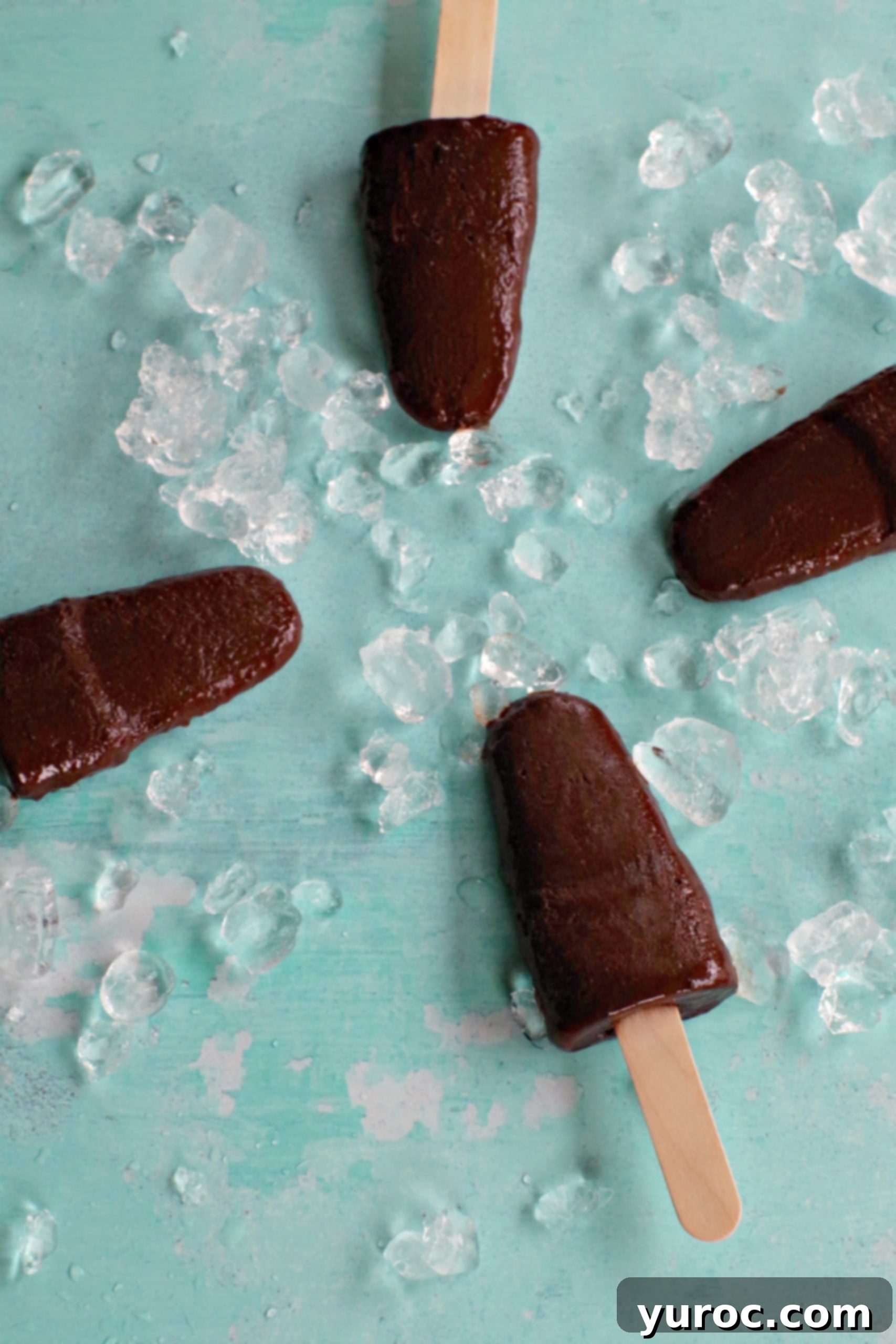 Decadent Yet Light Chocolate Banana Pops 6 4 chocolate banana popsicles on blue background with ice