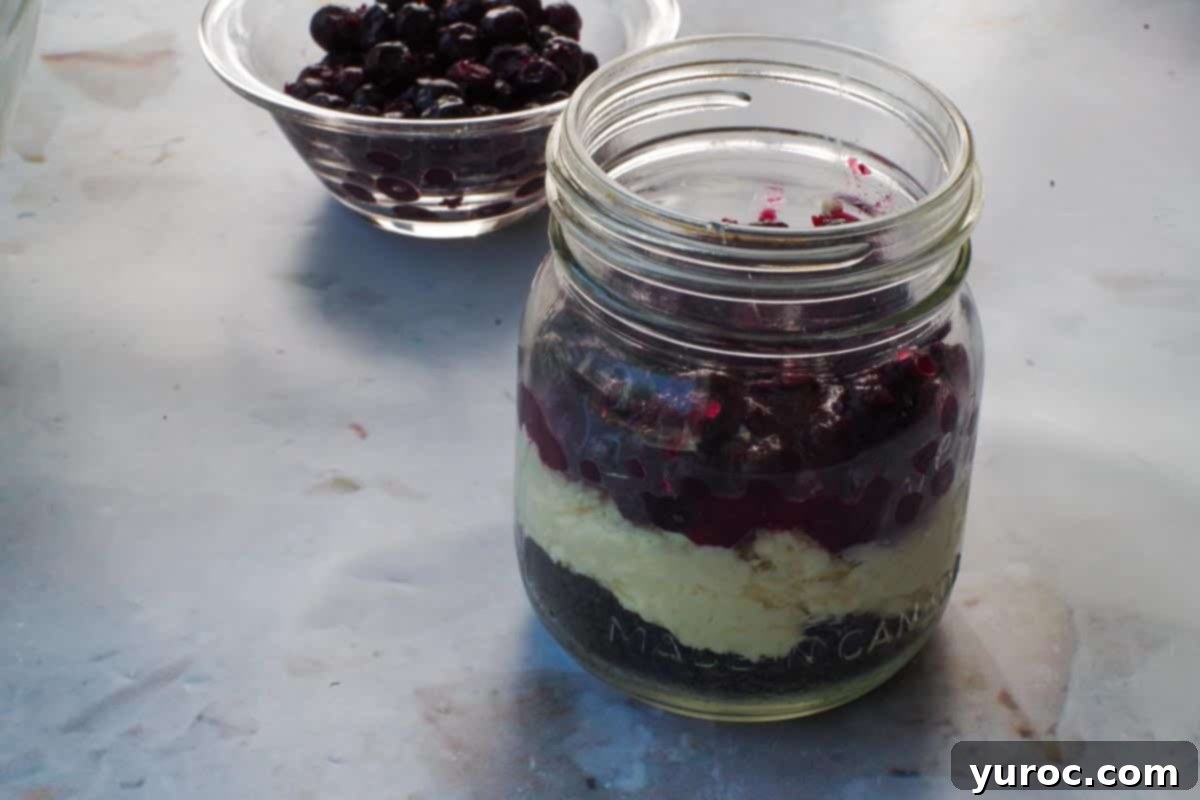 No-Bake Saskatoon Berry Cheesecake Jars 10 Saskatoon berry mixture added to jar on top of cream cheese mixture.