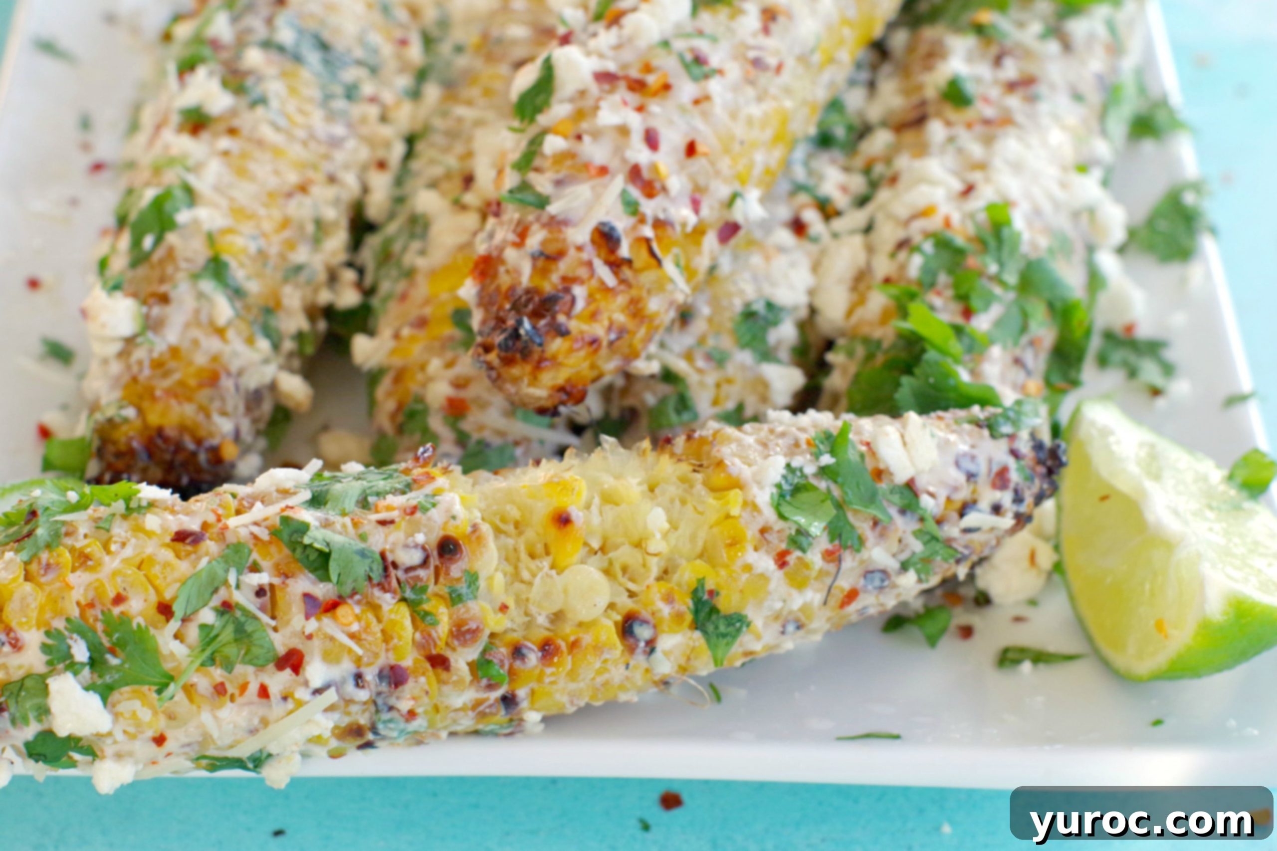 Mexican corn on the cob with bites taken out of it