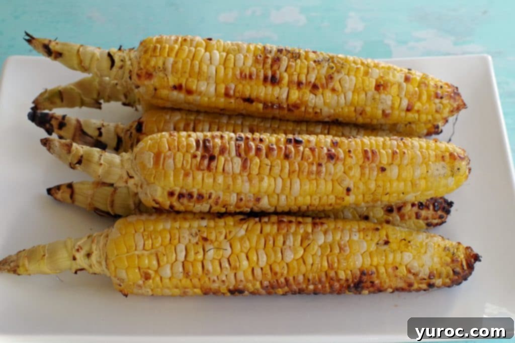 grilled corn on a white platter