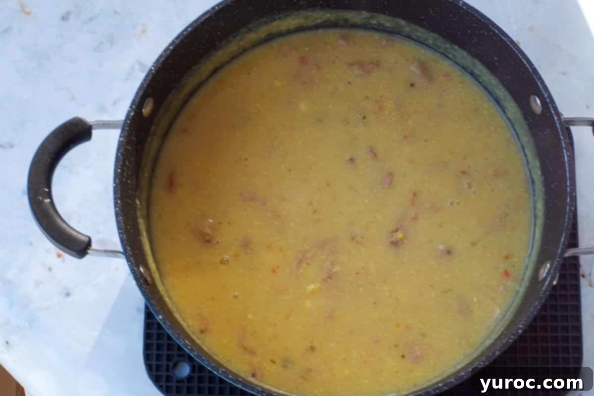 Wholesome Velvety Sweet Corn Chowder 9 The finished corn chowder in a pot, now with the remaining corn kernels and crumbled turkey bacon added back in, creating a visually appealing texture.