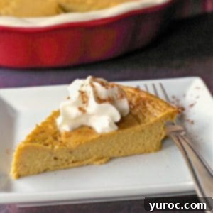 crustless pumpkin pie on a white plate with fork and whole pie in background