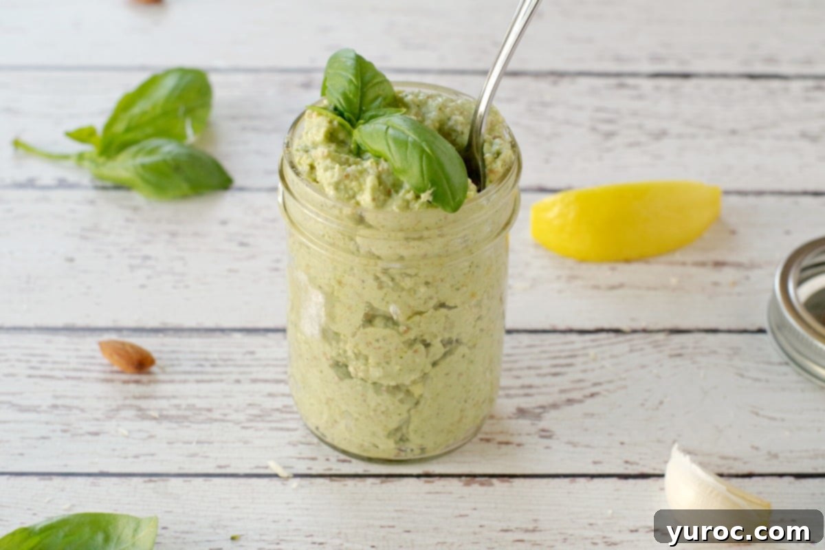 homemade basil pesto in a jar with lemon, garlic, basil and almond