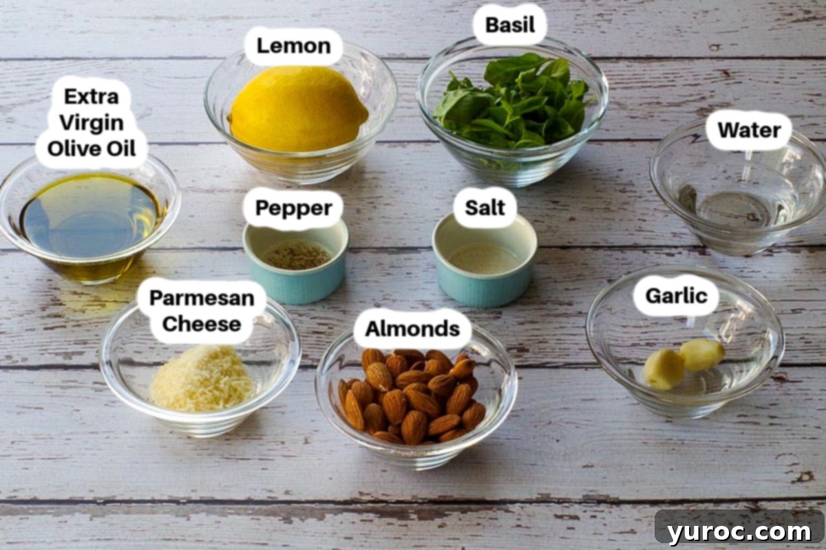 Ingredients in Basil Pesto with Almonds in glass bowls, labelled.