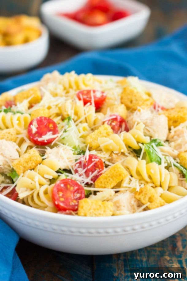 15 No-Prep Healthy School Lunches for Teens 11 chicken caesar pasta salad in white bowl with romaine lettuce, pasta, chicken, and Parmesan cheese