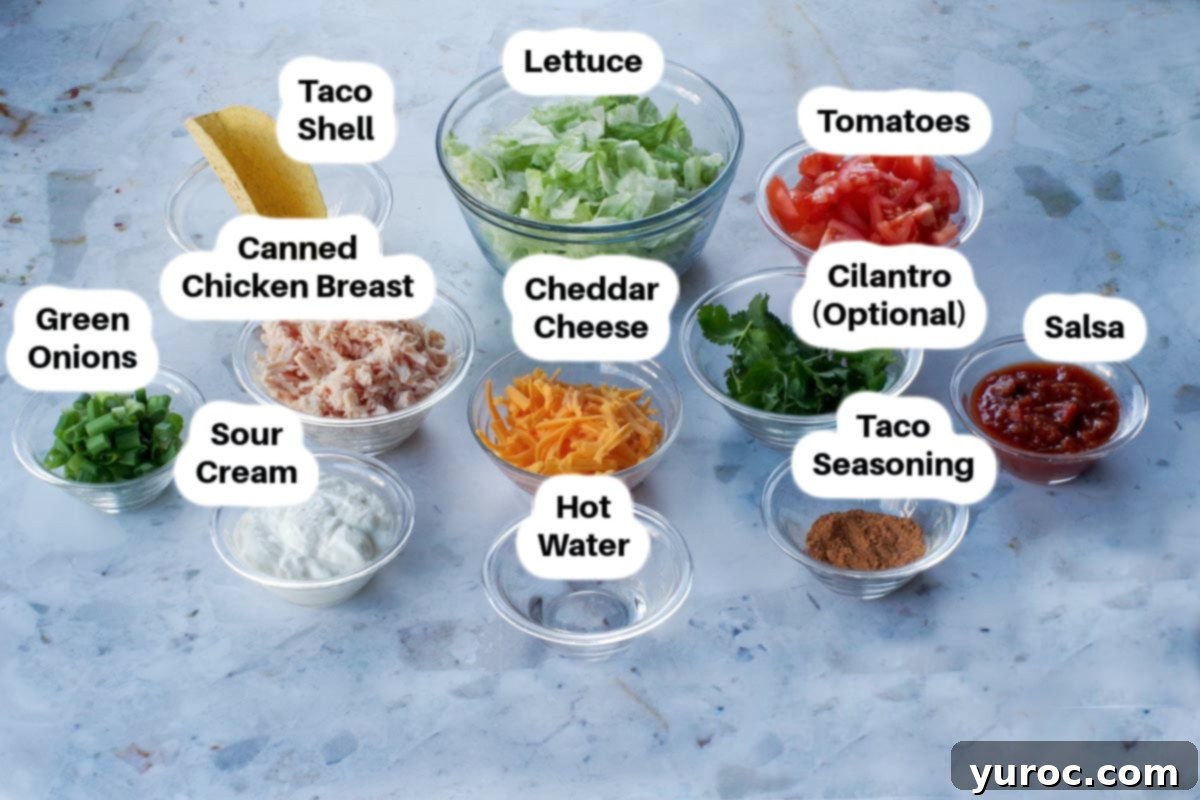 Mason Jar chicken taco salad ingredients in glass bowls, labelled.