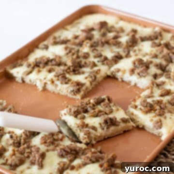 Breakfast Pizza on a sheet pan with piece being lifted up with pie lifter