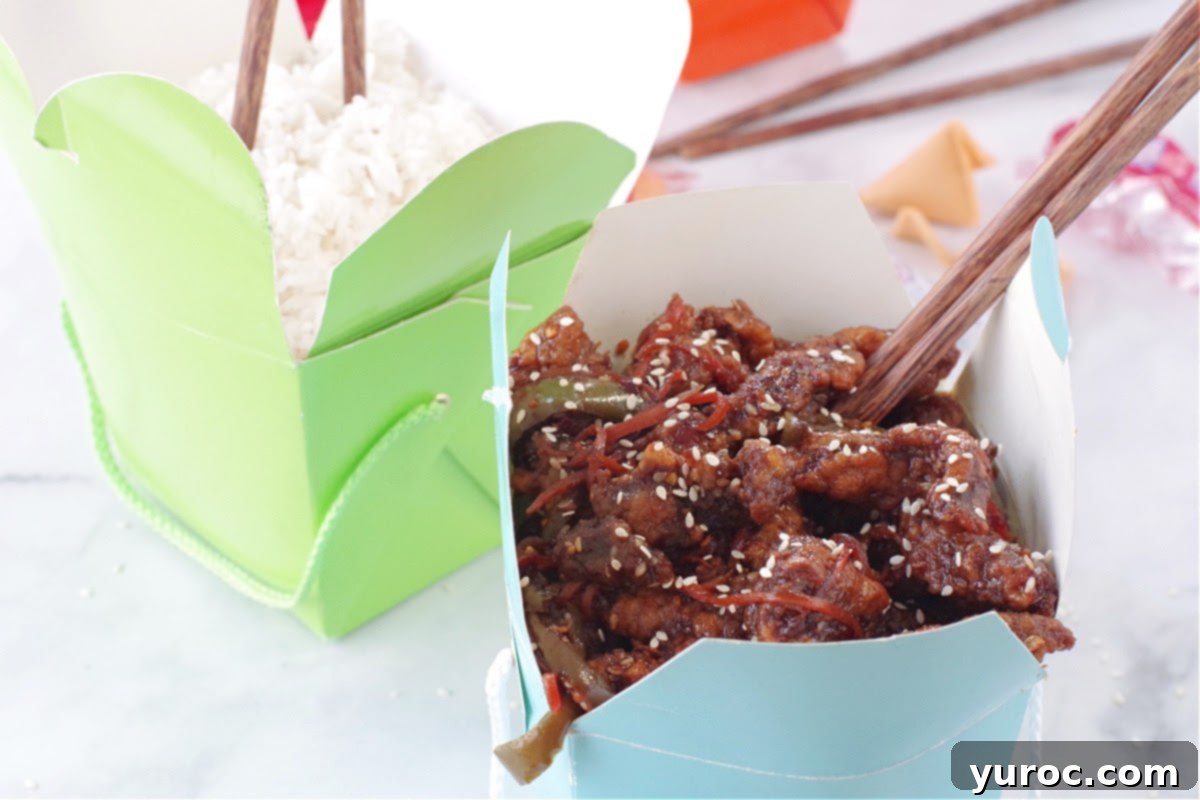 The Ultimate Calgary Ginger Beef 2 ginger beef in blue take-out container with chopsticks and green take-out container with rice in the background
