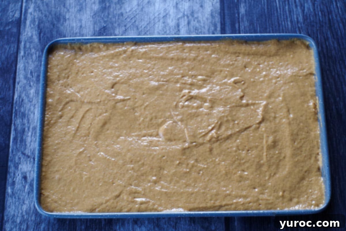 pumpkin pancake batter poured onto sheet pan