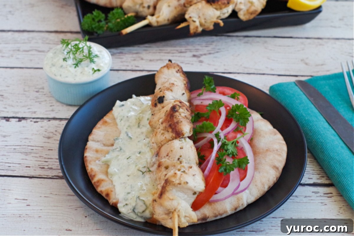 Greek Chicken Souvlaki on a pita with veggies and tzatziki sauce
