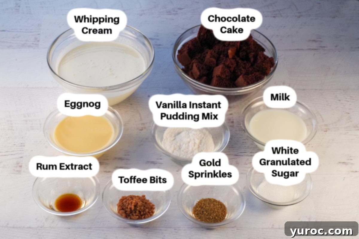 A selection of eggnog trifle ingredients laid out in clear glass bowls, including chocolate cake cubes, eggnog, whipped cream, toffee bits, and pudding mix, all clearly labelled for easy identification.