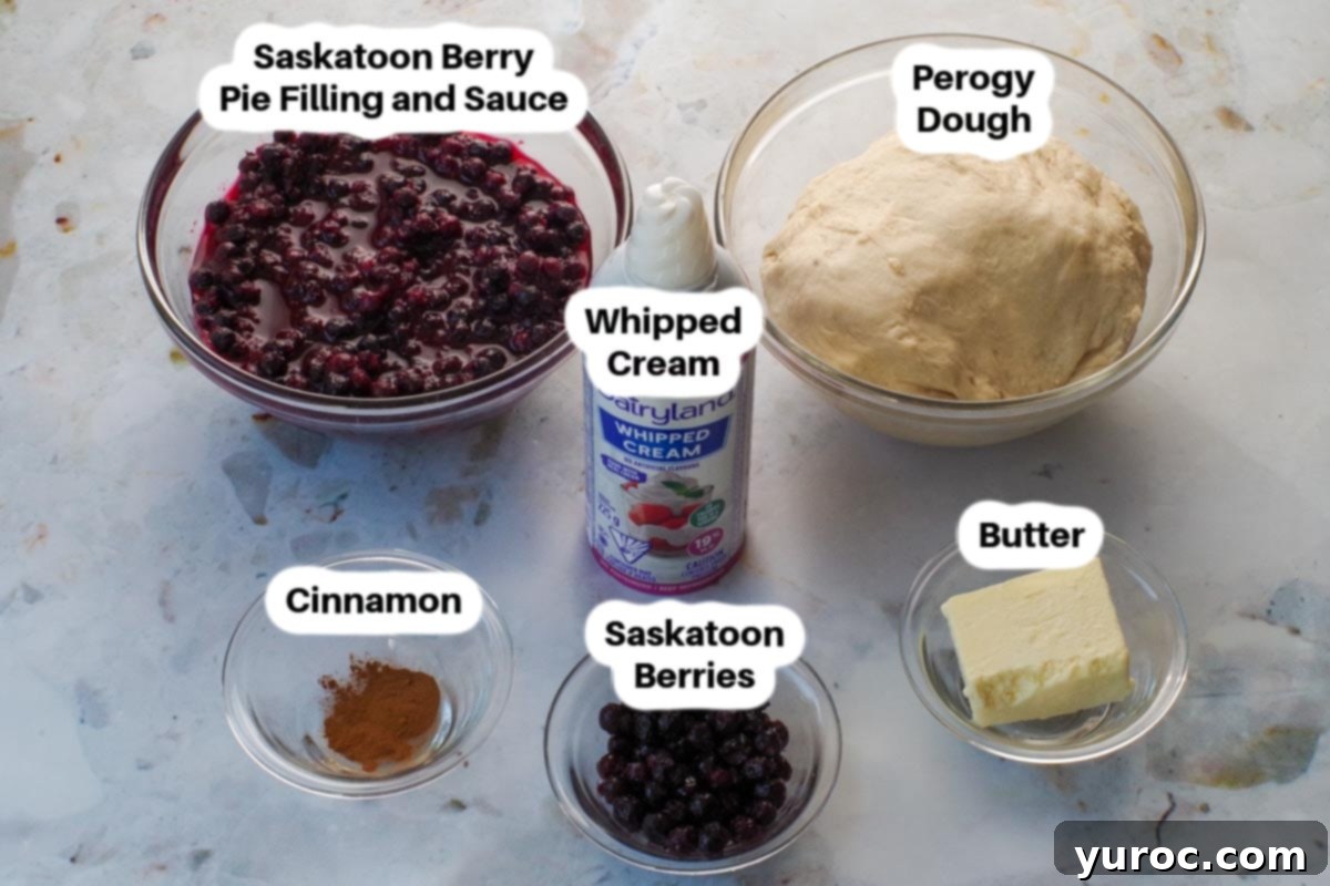 Saskatoon berry dessert perogy ingredients in glass bowls, neatly labelled, including berries, flour, and butter