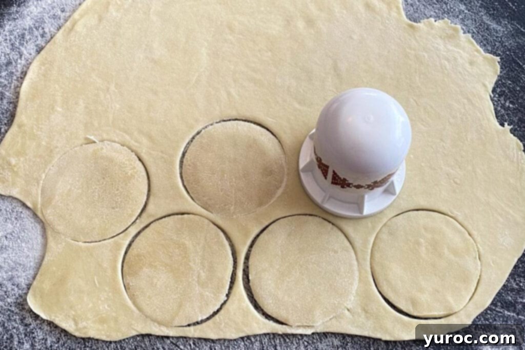 Perogy cutter in action, cutting circles from rolled out dough on a cutting board