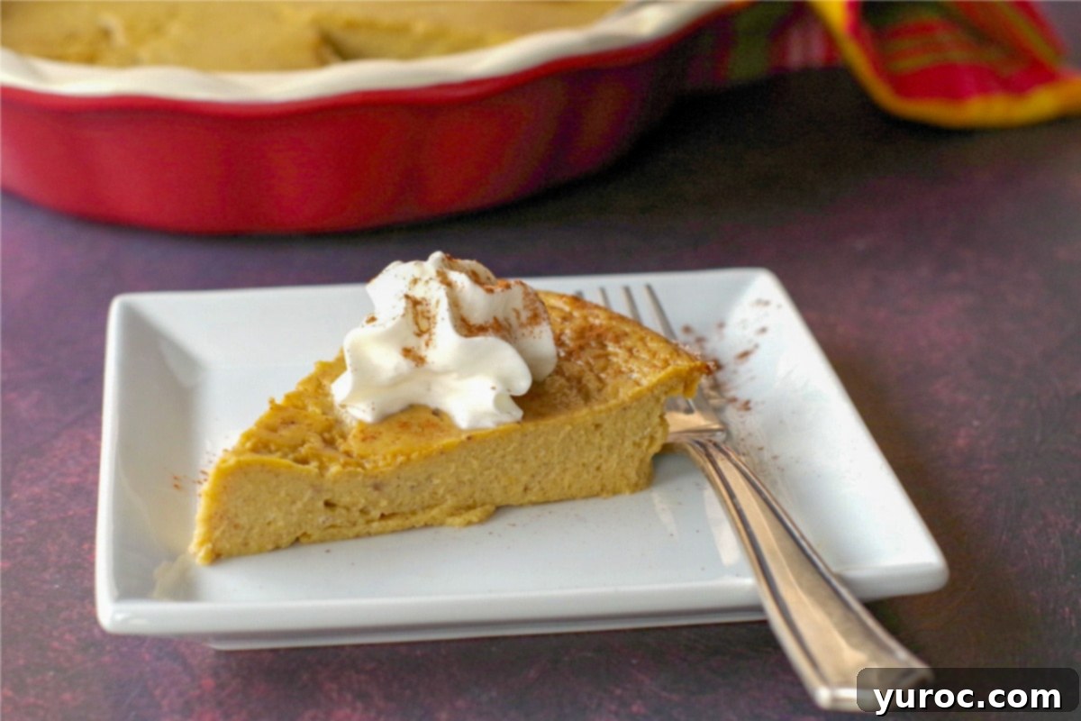 Light Pumpkin Oreo Cheesecake 12 A slice of crustless pumpkin pie on a white plate with a fork, and a whole pie in the background.