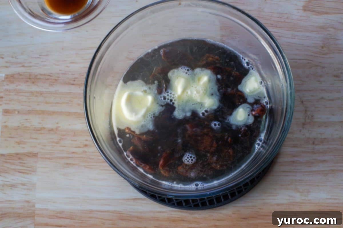 butter dates and boiling water in medium glass bowl